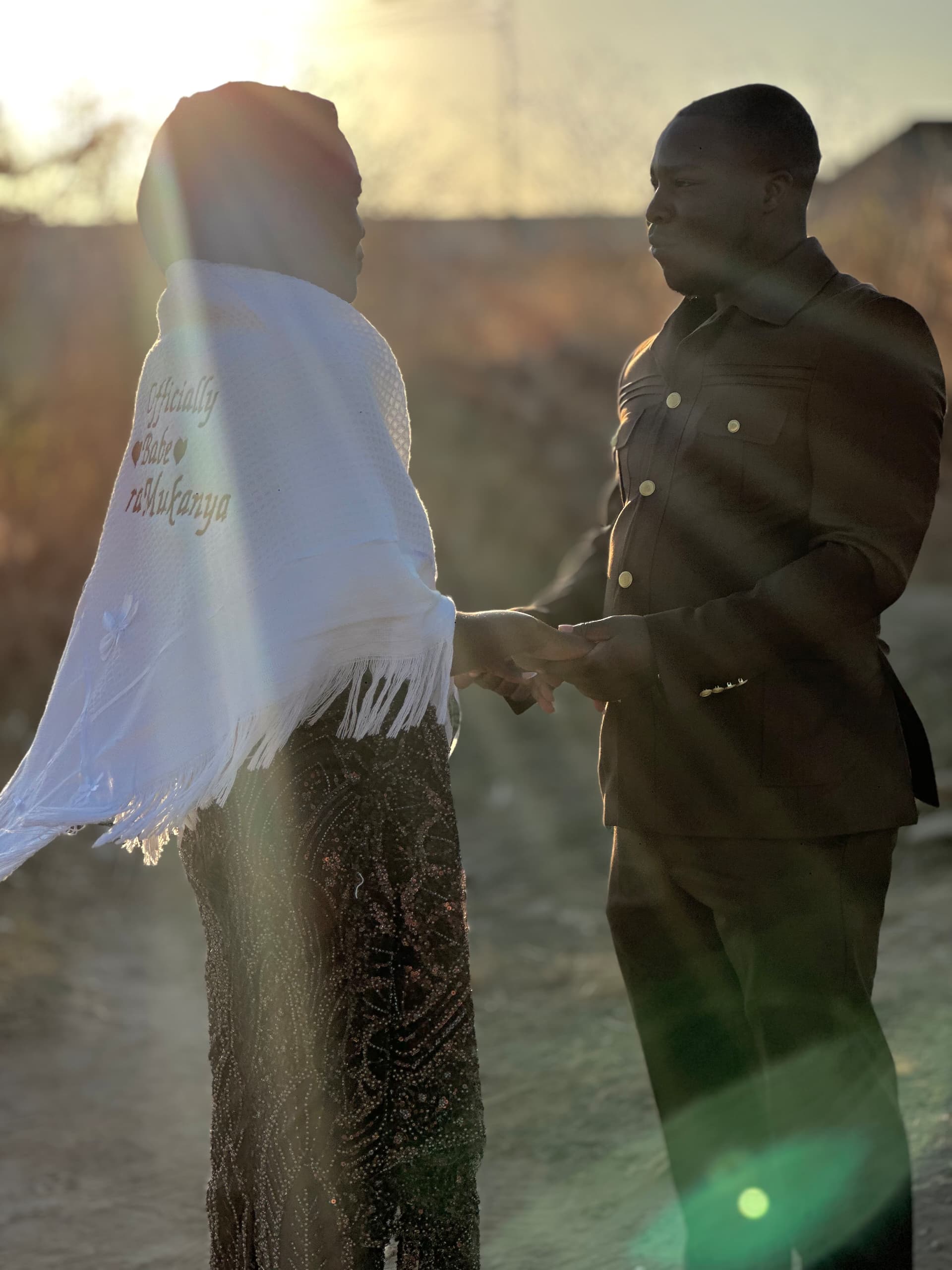 Valentine and Tanaka holding hands at golden hour